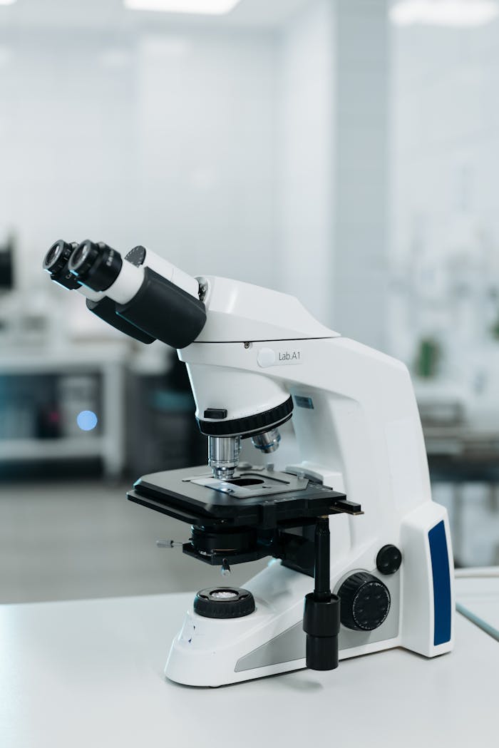 Digital microscopy image showcasing a modern laboratory microscope in a bright research environment.